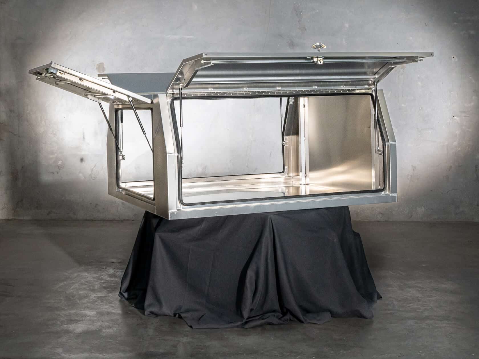 UTE canopy with lift-up doors open to reveal the internal storage area and reinforced framing