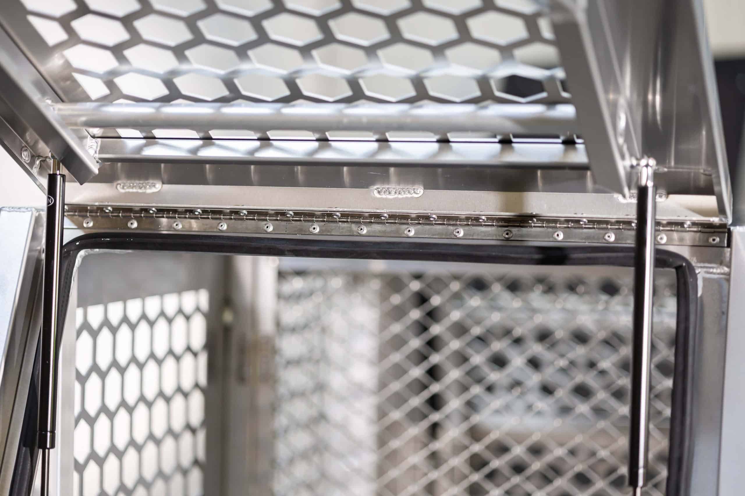 Interior view of the dog box section showing ventilation panels, gas struts, and reinforced aluminium framing
