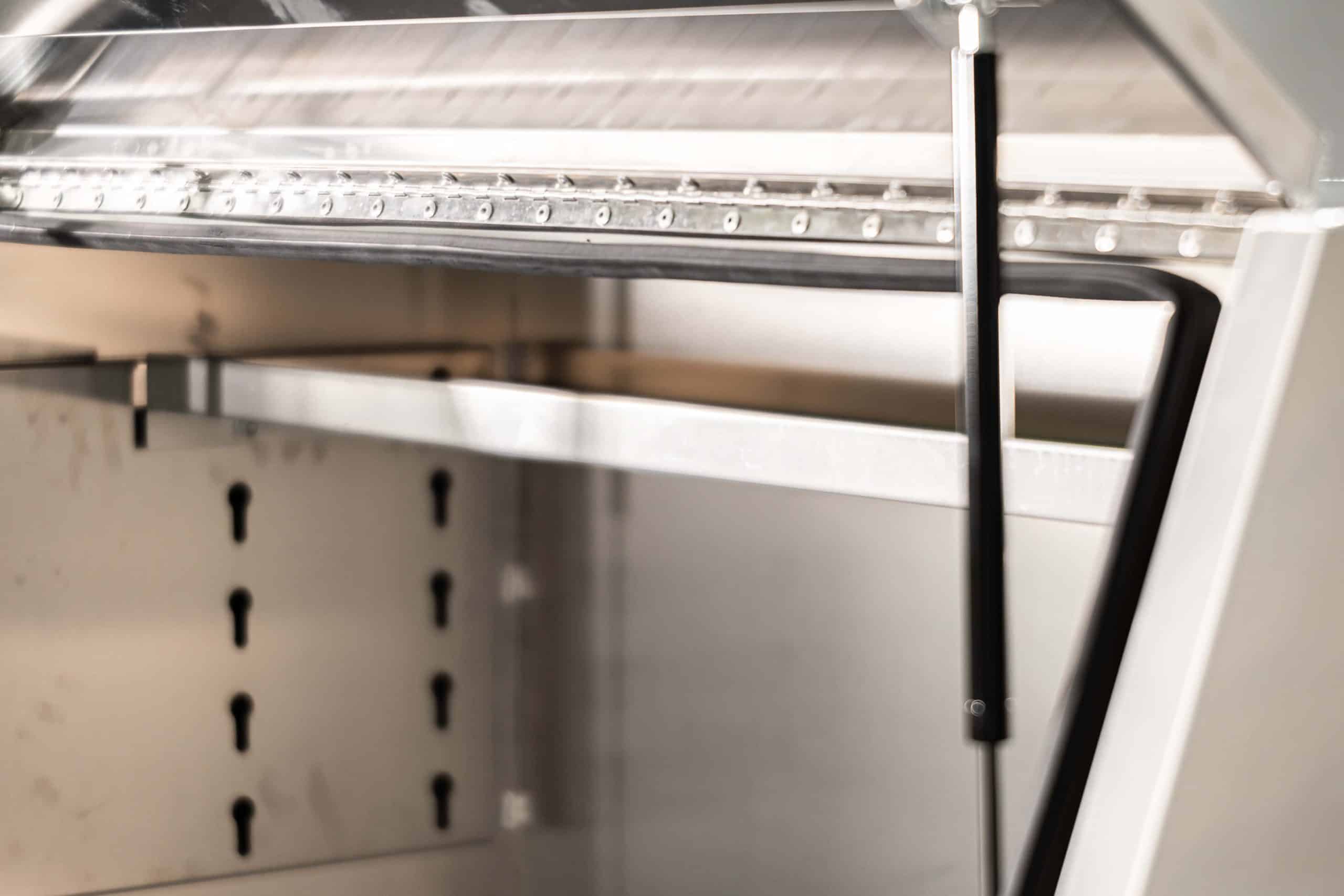 Dual gas struts assisting the lift-up door of a UTE canopy