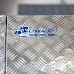 Close-up of UTE canopy logo badge mounted on aluminium surface