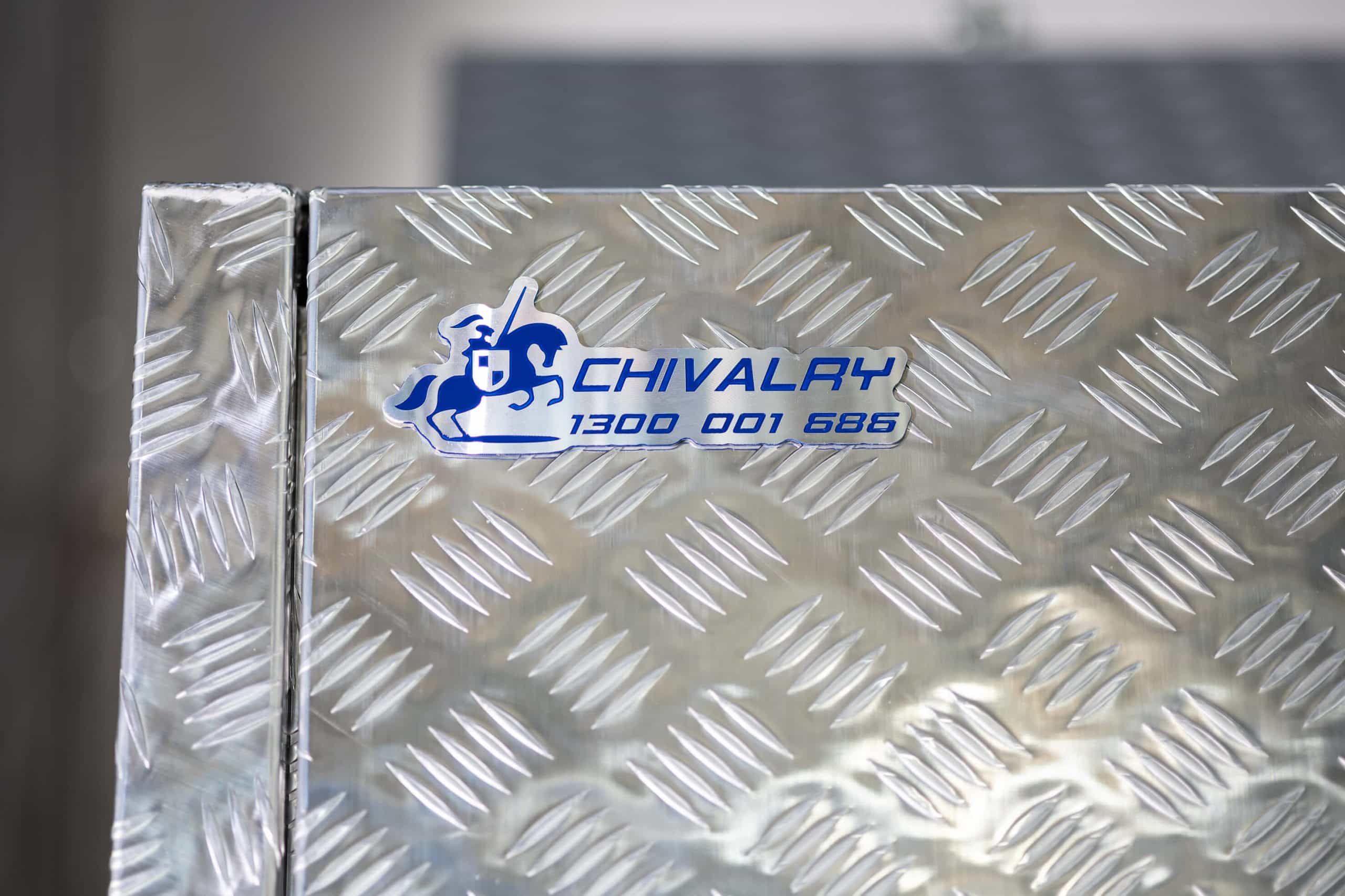 Close-up of UTE canopy logo badge mounted on aluminium surface