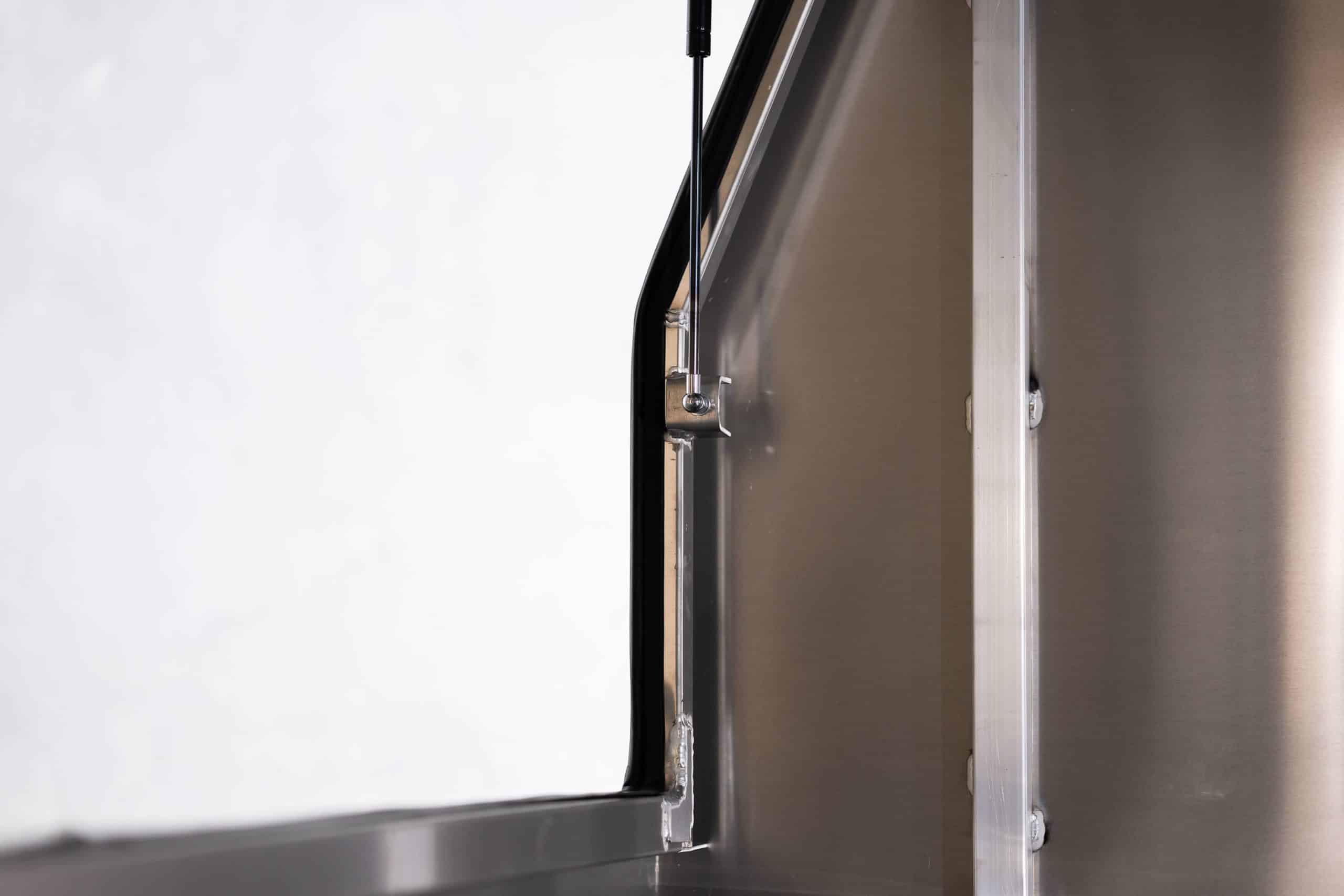 Close-up of a gas strut hinge on a UTE canopy