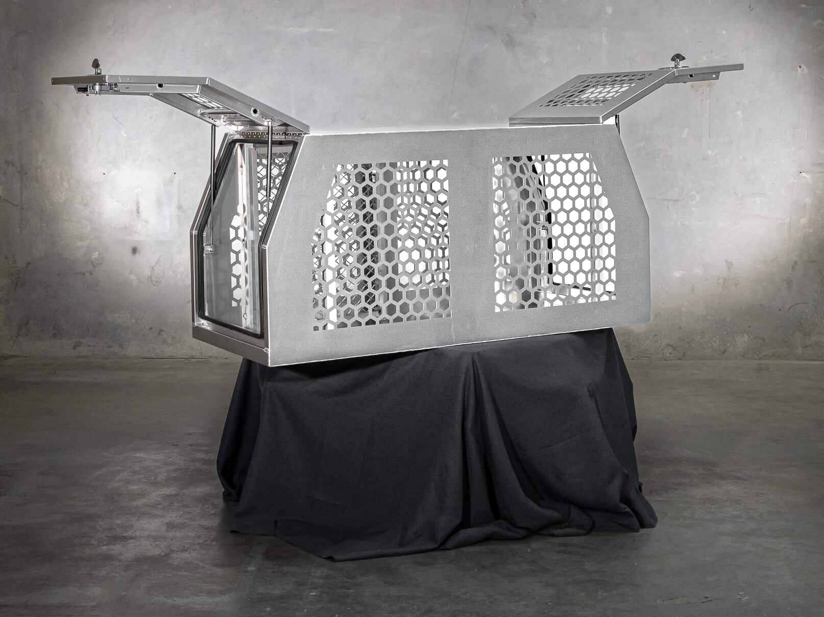 Heavy-duty aluminium dog box with airflow vents and top-opening access