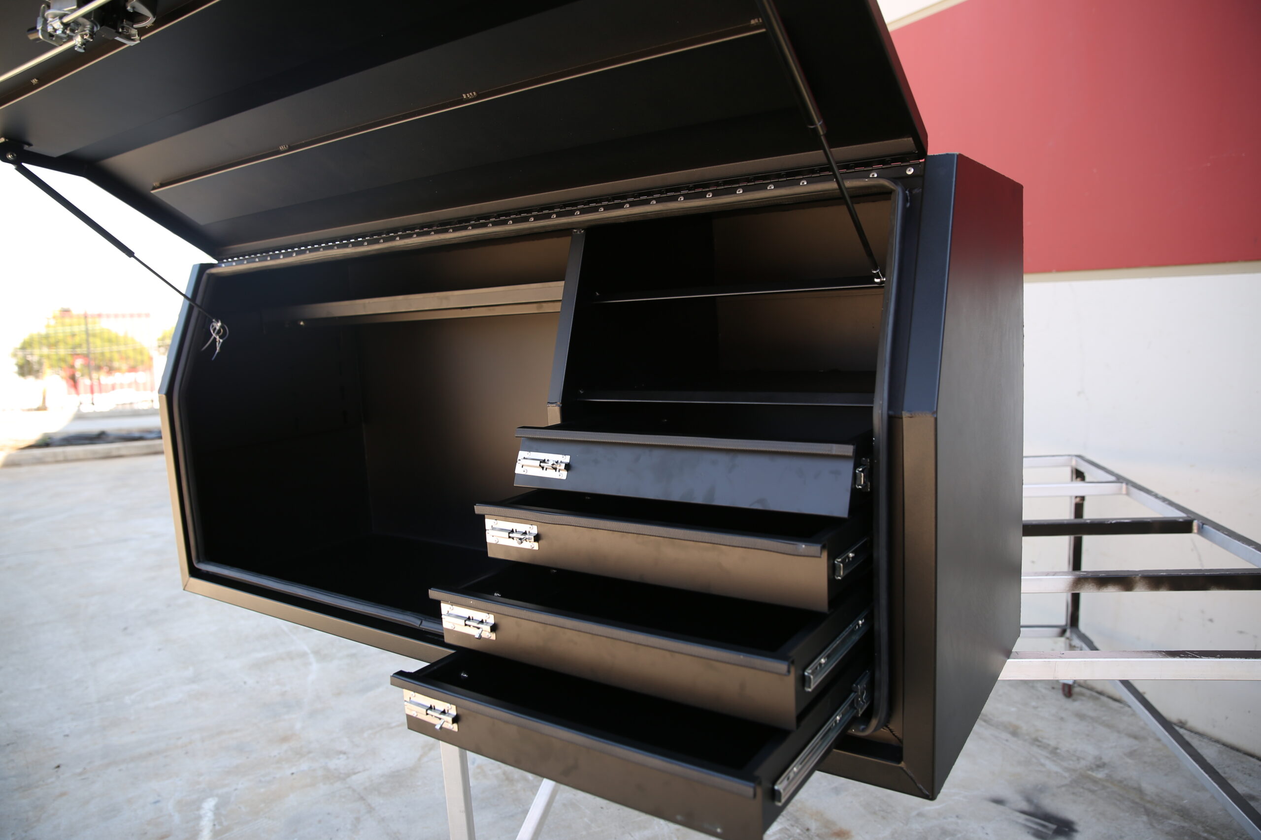 Black canopy interior featuring multiple storage shelves
