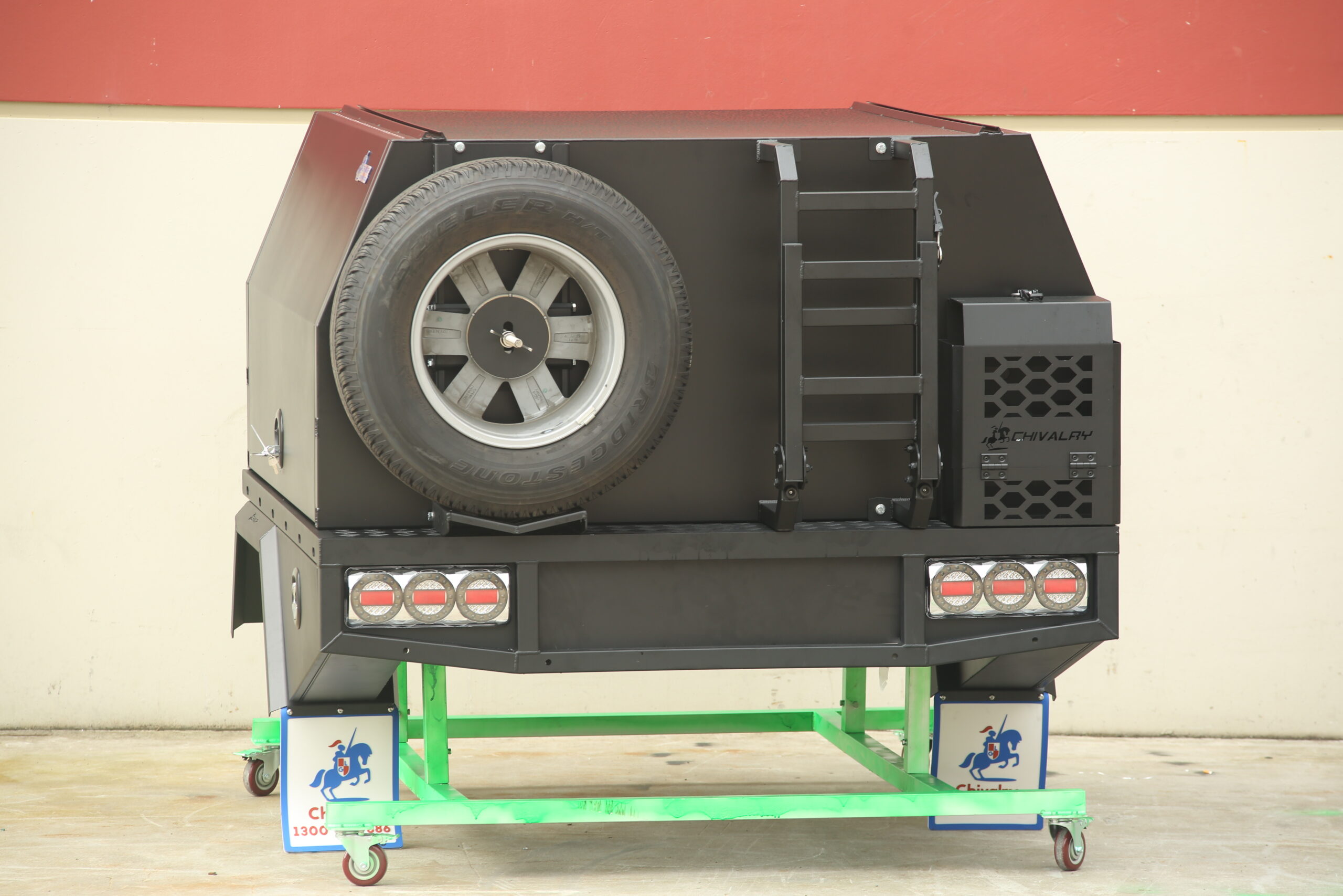 Black UTE canopy setup featuring storage drawers and ladder rack