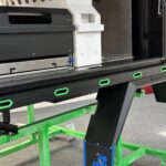 Close-up of a UTE canopy setup featuring green side rope covers along the frame for protection and style
